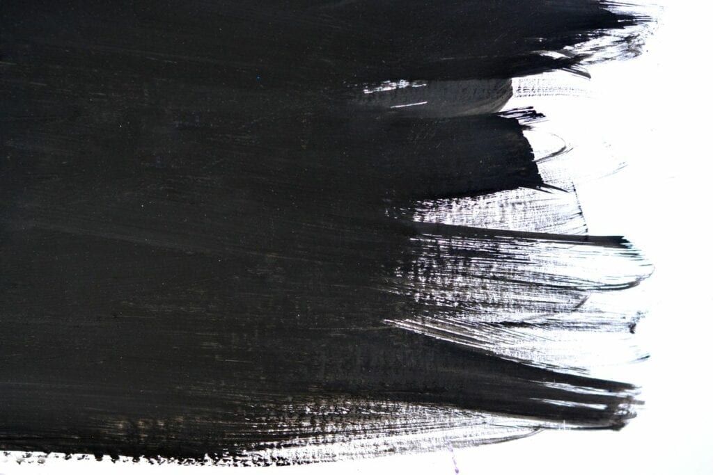 Thick black paint brush stroke on white